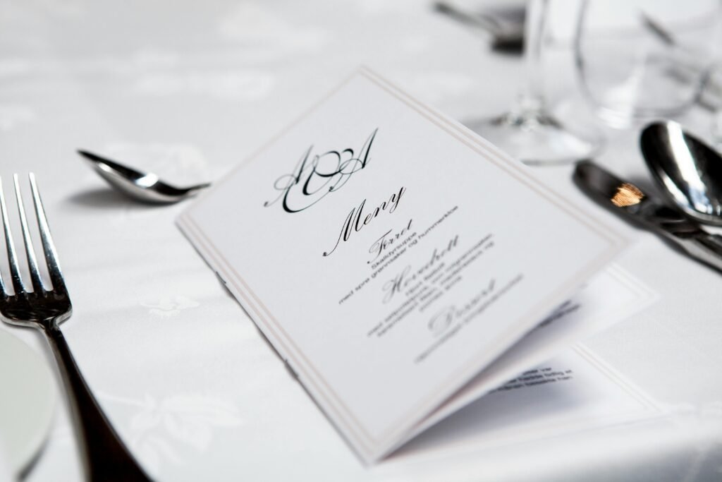 pexels-photo-313700-313700 Close-up of a refined dining table with menu and silverware, showcasing elegance in a formal restaurant setting.
